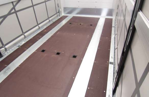 Stanchions inserted into the floor provide for form-fitting load securing